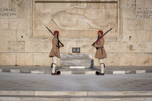 Ceremony of Presidential guard Evzones by the Greek tomb of Unknown Soldier. Evzones in summer uniform face each other, stand still. Close shot.
