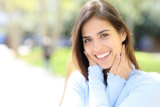 Beauty woman with white teeth smiling looking at camera in the street