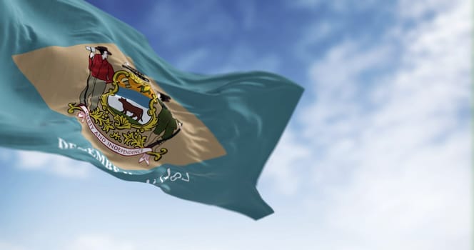 Delaware state flag waving on a clear day. Colonial blue background with a buff-colored diamond and state coat of arms, and December 7, 1787 below it. 3d illustration render. Fluttering fabric