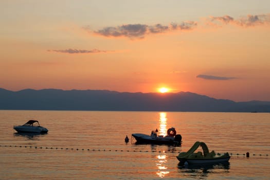 Evening mood on the Adriatic coast off Omisalj/island Krk in Croatia - while the setting sun makes for a fantastic picture,the boats are in the harbor  Theme picture Croatia / Hrvatska / Croatia 2023