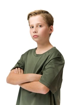 Three quarter waist view of a young teenager in a t-shirt and arms crossed looking pouty at the camera.