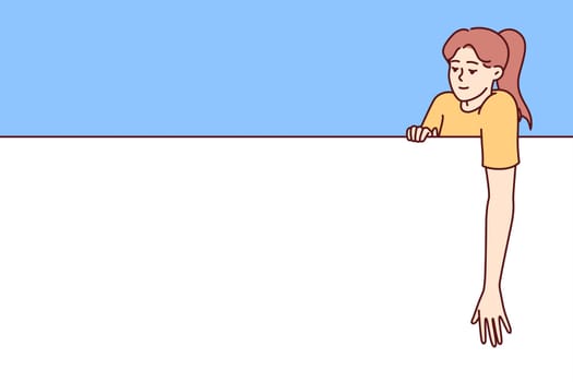 Woman with big empty banner looking at copy space for promotional offer or company logo. Young casual girl leans on giant empty banner designed to accommodate promotions or contact details.