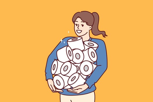Pile of toilet paper in hands of happy woman stocked up in case of quarantine or hurricane threat. Young girl holds lot of toilet paper bought during big discounts on hygiene products.