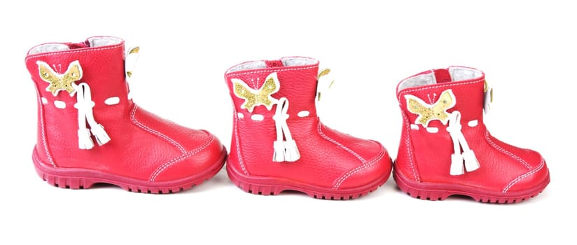 Red leather baby boots on white background