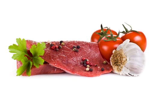 Raw beef frying steak with vegetables isolated over white background