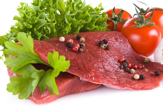 Raw beef frying steak with vegetables isolated over white background