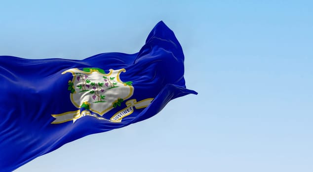 Connecticut state flag fluttering in the wind on a clear day. White shield on blue background featuring three grapevines each bearing bunches of grapes. 3d illustration render. Fluttering fabric