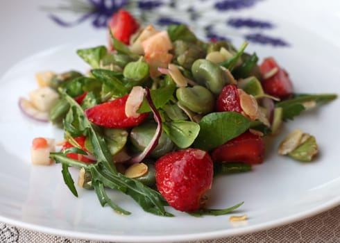 salad with strawberries and broad beans. Delicious dish in a healthy style
