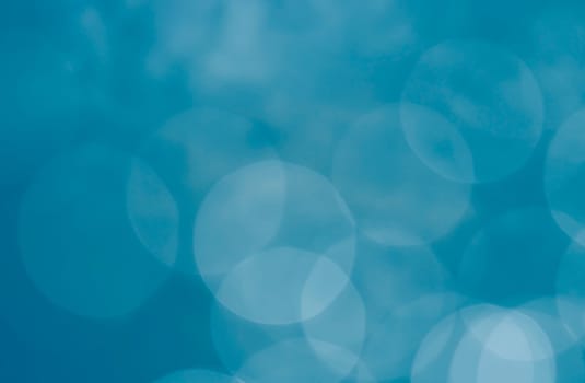 Light abstract blue bokeh christmas circle color glitter blurred black background