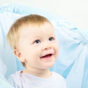 beautiful laughing baby with blue eyes portrait