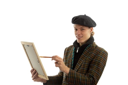 Young smiling artist with a beret on his head on a white background