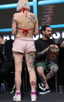Krakow, Poland - June 11, 2022: Unidentified participant during the contest for the best tattoo at the 15th Tattoofest Convention in Cracow. One of the most prestigious tattoo festivals.
