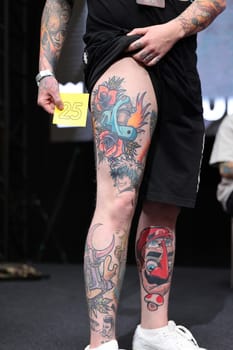 Krakow, Poland - June 11, 2022: Unidentified participant during the contest for the best tattoo at the 15th Tattoofest Convention in Cracow. One of the most prestigious tattoo festivals.