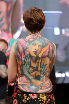 Krakow, Poland - June 12, 2022: Unidentified participant during the contest for the best tattoo at the 15th Tattoofest Convention in Cracow. One of the most prestigious tattoo festivals.