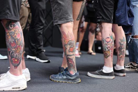 Krakow, Poland - June 11, 2022: Unidentified participant during the contest for the best tattoo at the 15th Tattoofest Convention in Cracow. One of the most prestigious tattoo festivals.