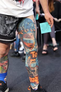 Krakow, Poland - June 12, 2022: Unidentified participant during the contest for the best tattoo at the 15th Tattoofest Convention in Cracow. One of the most prestigious tattoo festivals.