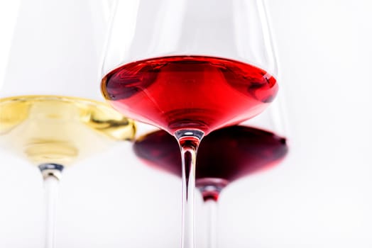 Three glass of red, rose and white wine isolated over white background. Wine card menu design. Closeup of wineglasses with luxury wine.