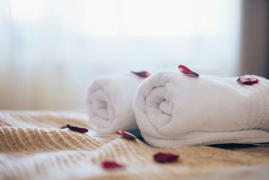 Luxury spa hotel room for romantic weekend. Honeymoon suite bedroom decorated with rose petals.
