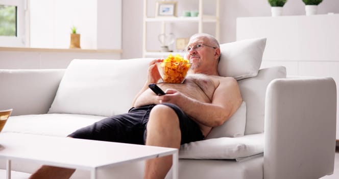 Sitting Overeating Food Lifestyle. Overweight People Watching Television