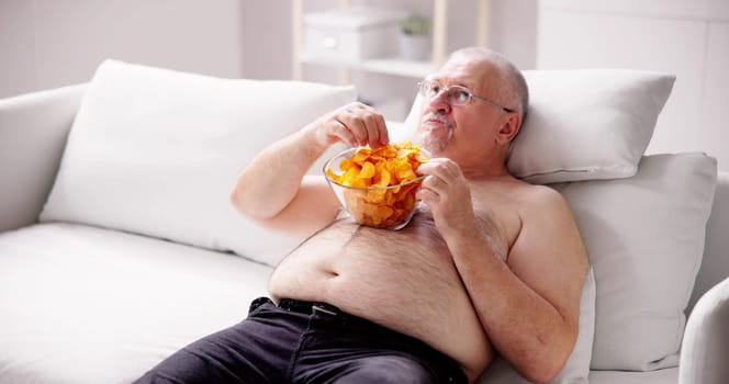 Sitting Overeating Food Lifestyle. Overweight People Watching Television