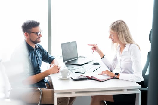 Business meeting. Client consulting. Confident business woman, real estate agent, financial advisor explaining details of project or financial product to client in office