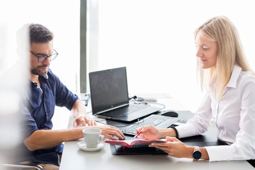 Business meeting. Client consulting. Confident business woman, real estate agent, financial advisor explaining details of project or financial product to client in office