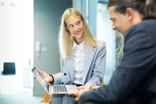 Business meeting. Client consulting. Confident business woman, real estate agent, financial advisor explaining details of project or financial product to client in office