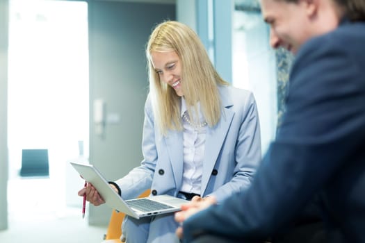 Business meeting. Client consulting. Confident business woman, real estate agent, financial advisor explaining details of project or financial product to client in office