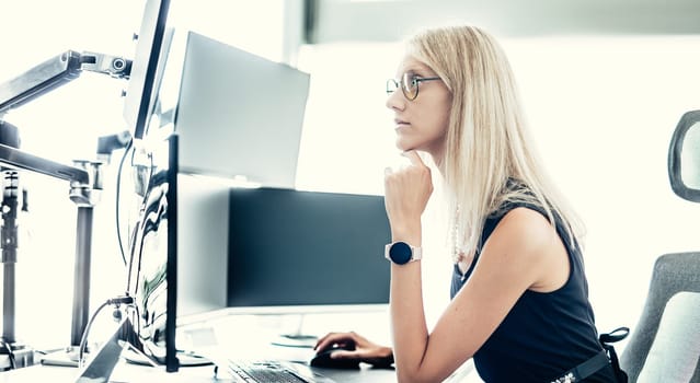 Female financial assets manager, trading online, watching charts and data analyses on multiple computer screens. Modern corporate business woman concept.