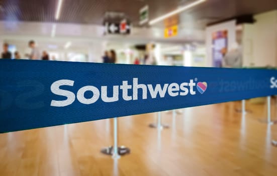 Atlanta, US Jan 2023: Blue barrier tape with the Southwest Airlines logo inside an airport. Southwest the largest low-cost carrier in the world. Travel and airport security. Illustrative editorial