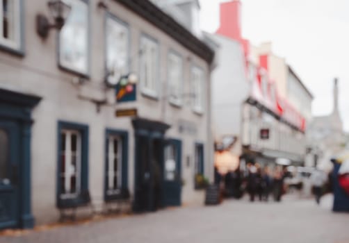 Blurred abstract street view of old town buildings and shopping stores with bokeh lights background