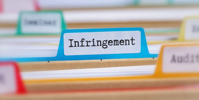 File folders with a tab labeled Infringement