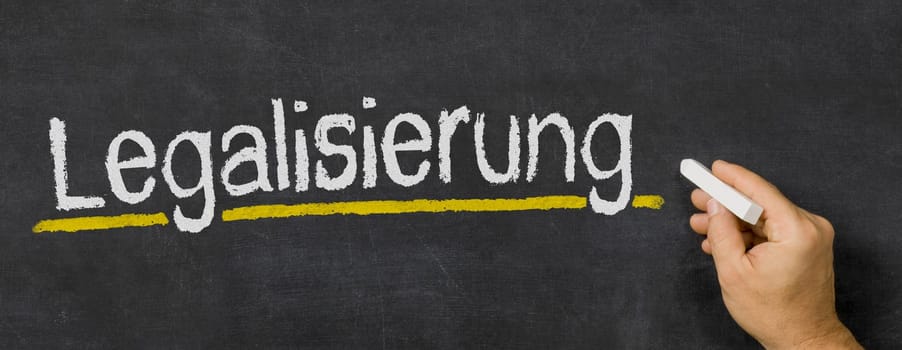 Text written on a blackboard - Legalization in german - Legalisierung