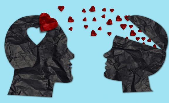Paper silhouettes of man and woman from crumpled black paper and red hearts, love concept