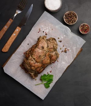 Baked pork collar with spices on a wooden board, delicious and juicy meat