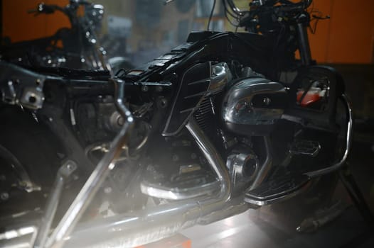 Closeup shot of modern powerful motorbike engine block and chromed exhaust pipes with shiny reflexive surface