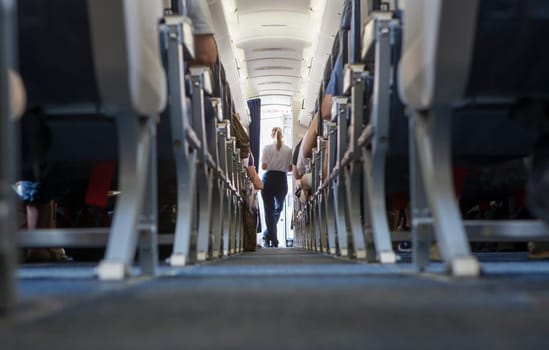 Normal class passenger jet airliner corridor. Ground view