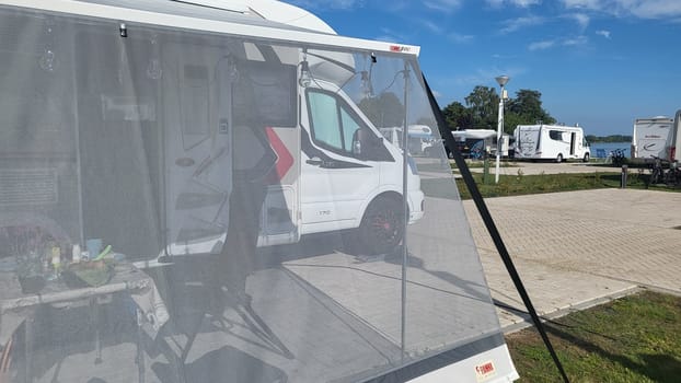 Blitterswijck, The Netherlands - August 21, 2022: Campers parked on a Camer Van pitch. Concept camper van leisure and fun