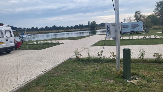 Blitterswijck, The Netherlands - August 22, 2022: Campers parked on a Camer Van pitch. Concept camper van leisure and fun