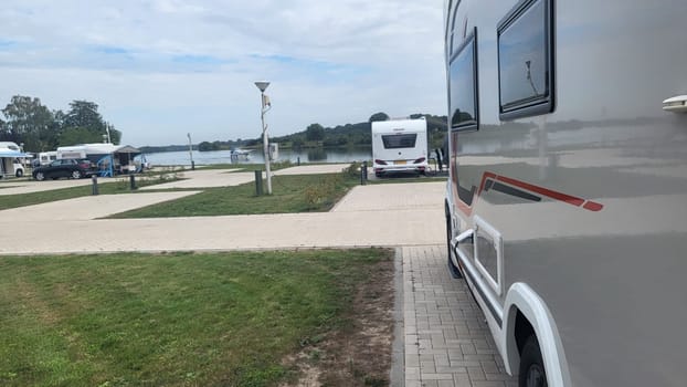 Blitterswijck, The Netherlands - August 22, 2022: Campers parked on a Camer Van pitch. Concept camper van leisure and fun