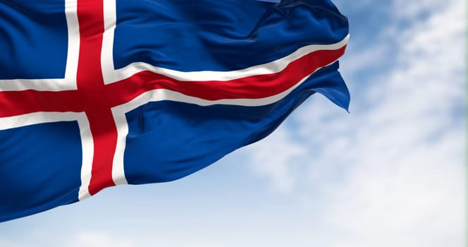 Iceland national flag waving in the wind on a clear day. Blue flag with a white-edged red Nordic cross. 3d illustration render. Fluttering fabric.