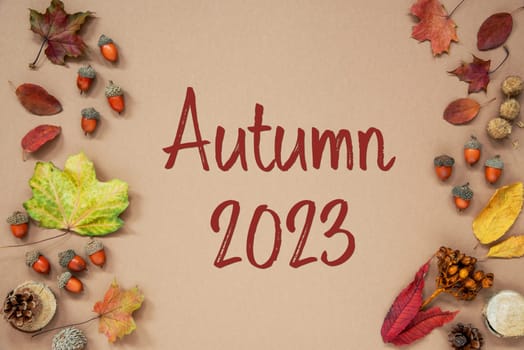 Autumn Background with Autumn Decoration, With Acorns and Fall Leaves and Text Autumn 2023