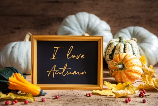 Autumn Pumpkin Decoration With English Text I love Autumn. Wooden Background with Corlorful Rustic Fall Decor Like Leaf And Golden Picture Frame