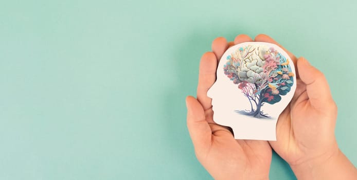 Hands holding paper head, human brain with flowers, self care and mental health concept, positive thinking, creative mind, generative AI used for brain