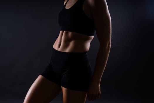 Fitness woman showing abs flat belly, isolated. Athletic female shaped abdominal