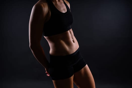 Fitness woman showing abs flat belly, isolated. Athletic female shaped abdominal
