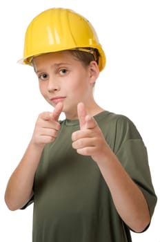 Waist up view of young teenage boy wearing yellow helmet pointing fingers at camera.