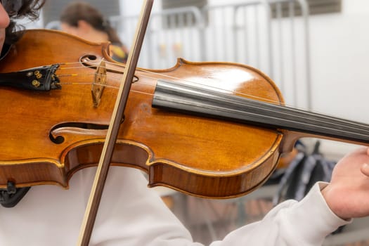 Real life young music students during rehearsals. Musical instruments and music stand with stave. Violin, drums, viola, flute