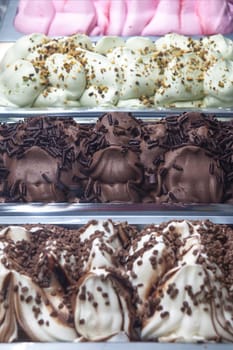 Display counter with assorted ice cream flavours. Selective focus