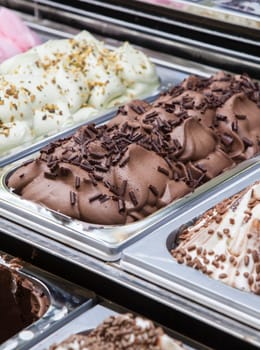 Display counter with assorted ice cream flavours. Selective focus